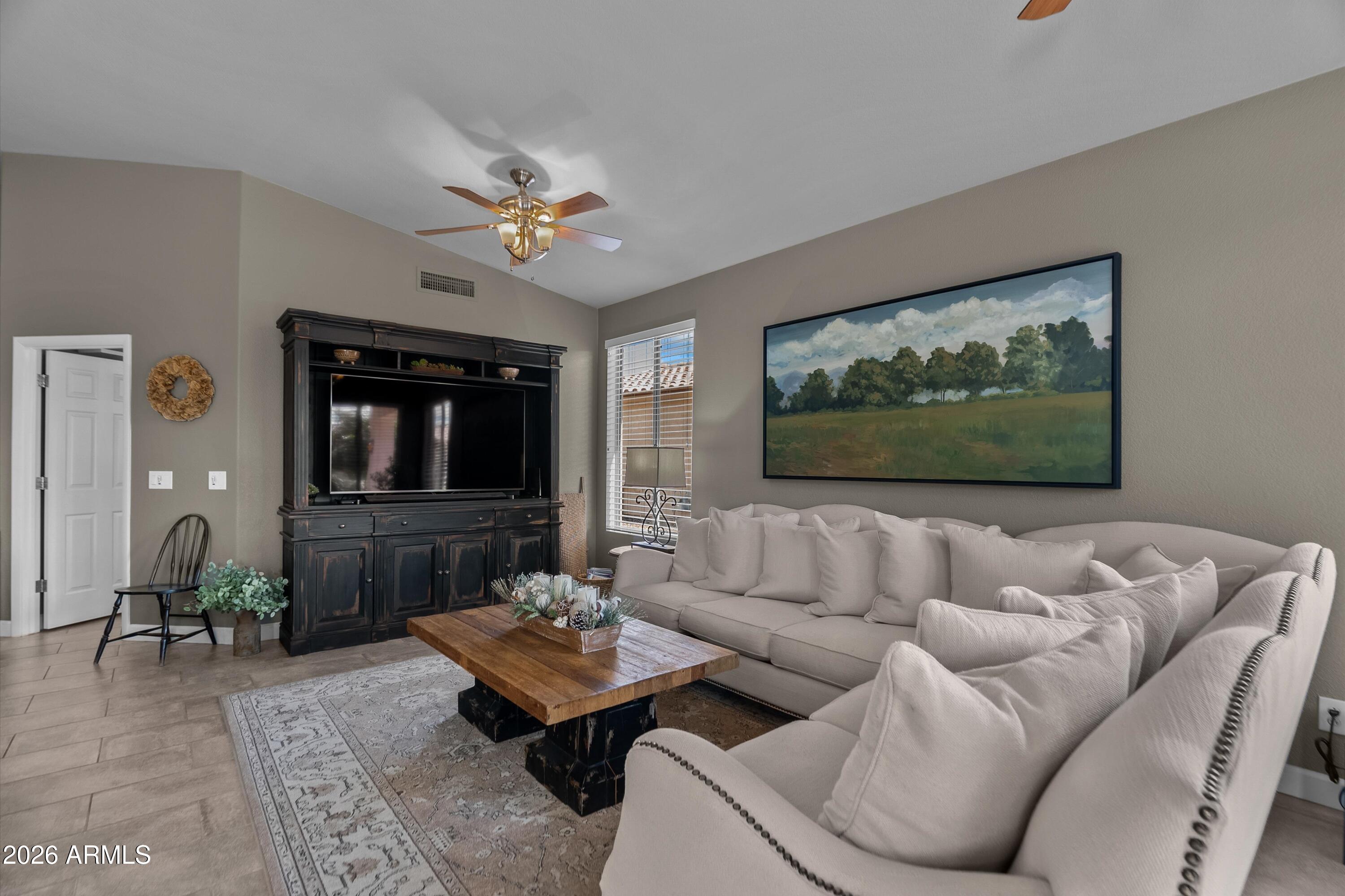 4685 East Walnut Road Gilbert, AZ 85298 - Photo 4 of 58 a living room with furniture and a flat screen tv
