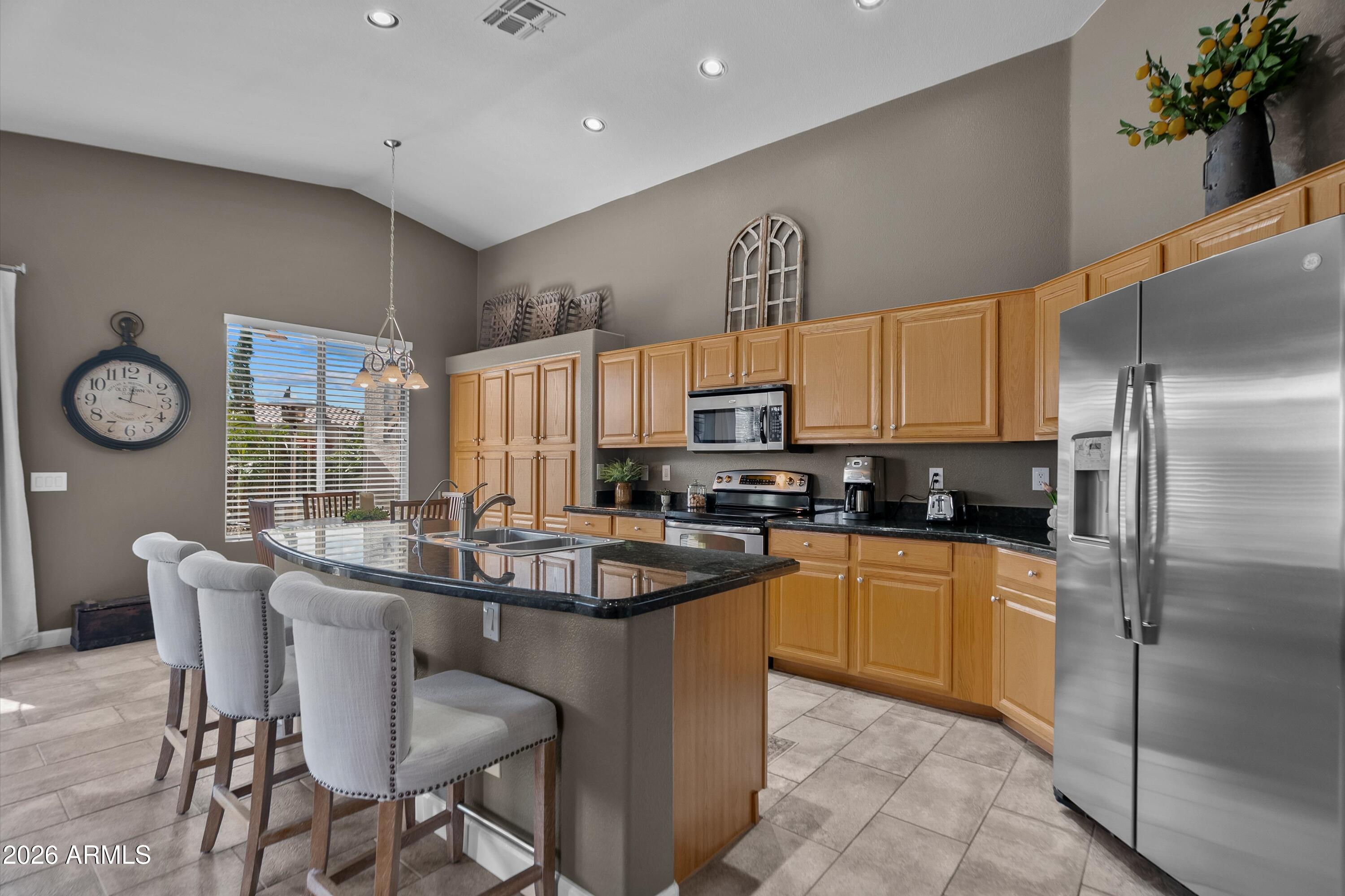 4685 East Walnut Road Gilbert, AZ 85298 - Photo 8 of 58 a kitchen with granite countertop a sink stainless steel appliances and cabinets