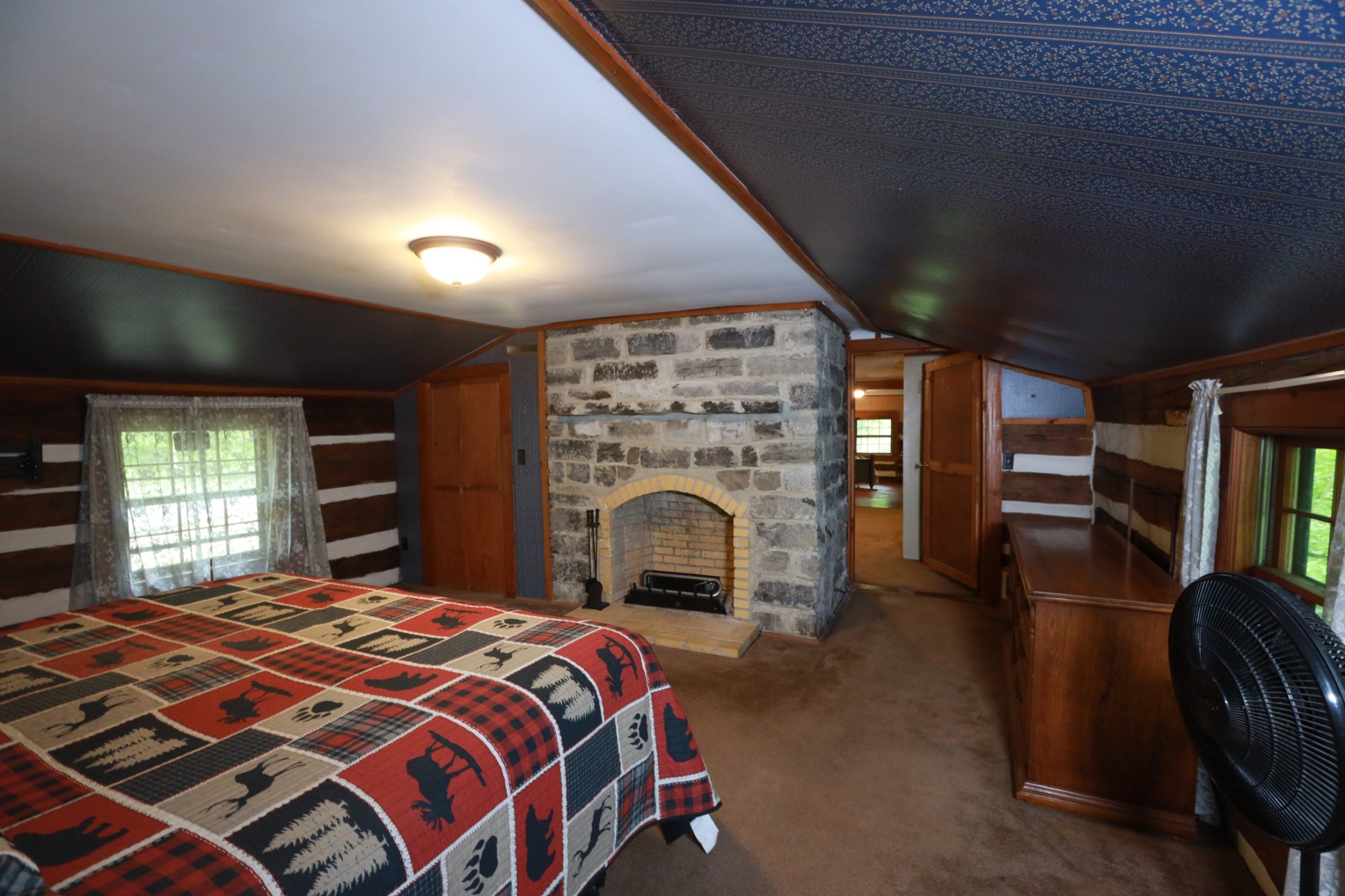 2634 Distillery Road Greenbrier, TN 37073 - Photo 16 of 35 a bed sitting in a spacious bedroom next to a window and a fireplace