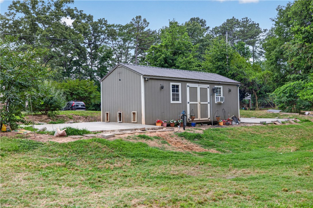206 James Hare Road Anderson, SC 29626 - Photo 10 of 37 A versatile outbuilding provides ample storage and practical utility in this expansive yard.