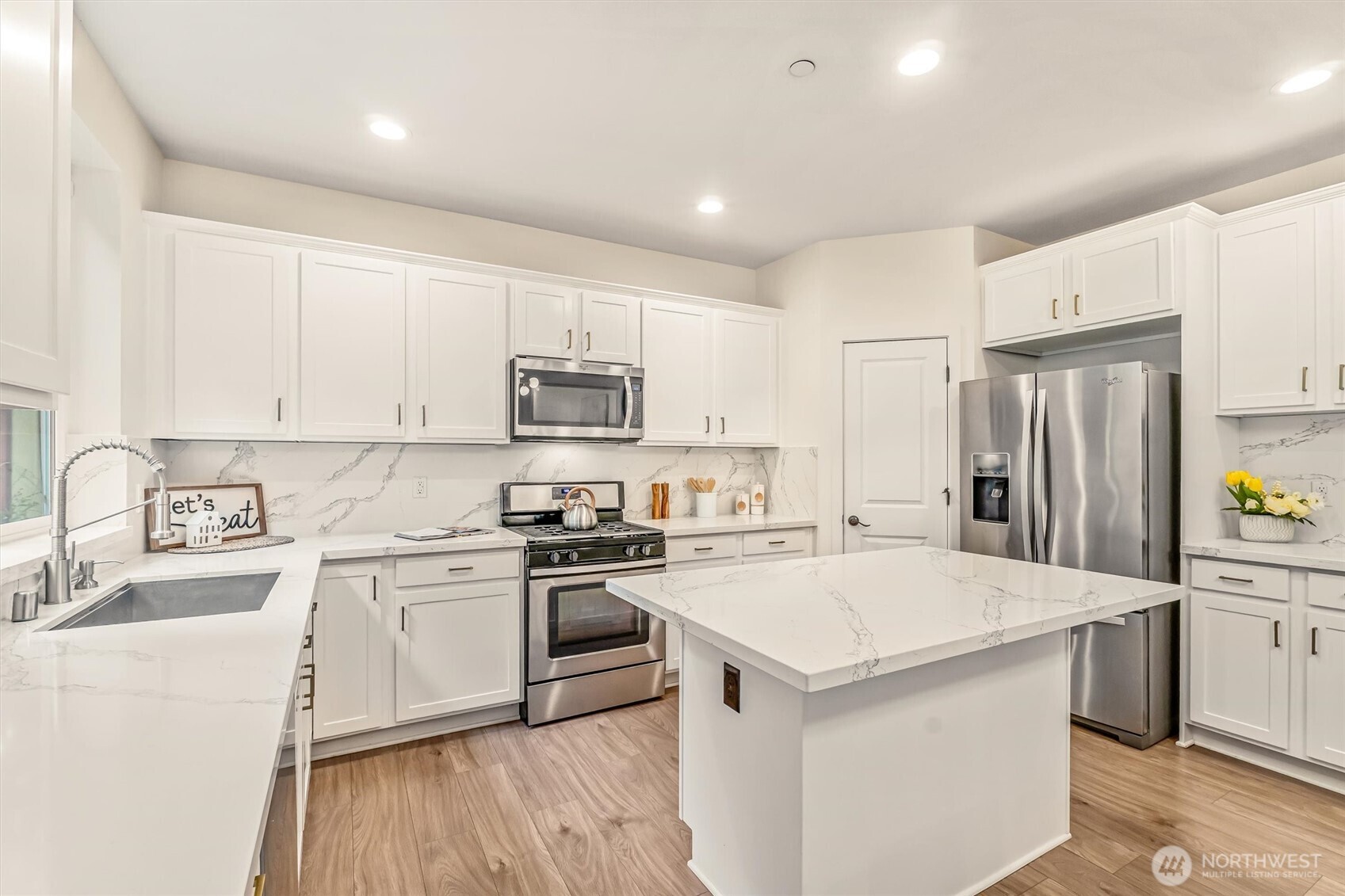 9213 Odin Way Bothell, WA 98011 - Photo 11 of 40 a kitchen with a sink a stove a refrigerator and white cabinets