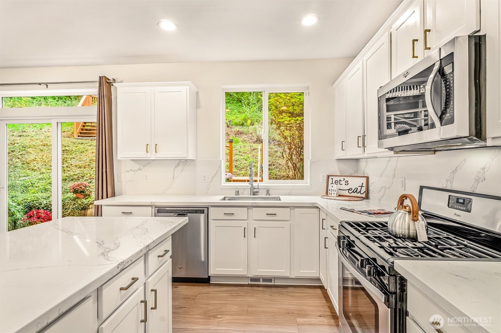 9213 Odin Way Bothell, WA 98011 - Photo 13 of 40 a kitchen with a sink stove top oven and refrigerator