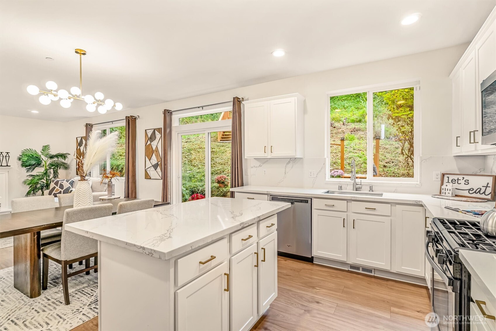 9213 Odin Way Bothell, WA 98011 - Photo 14 of 40 a kitchen with a stove a sink a center island and windows