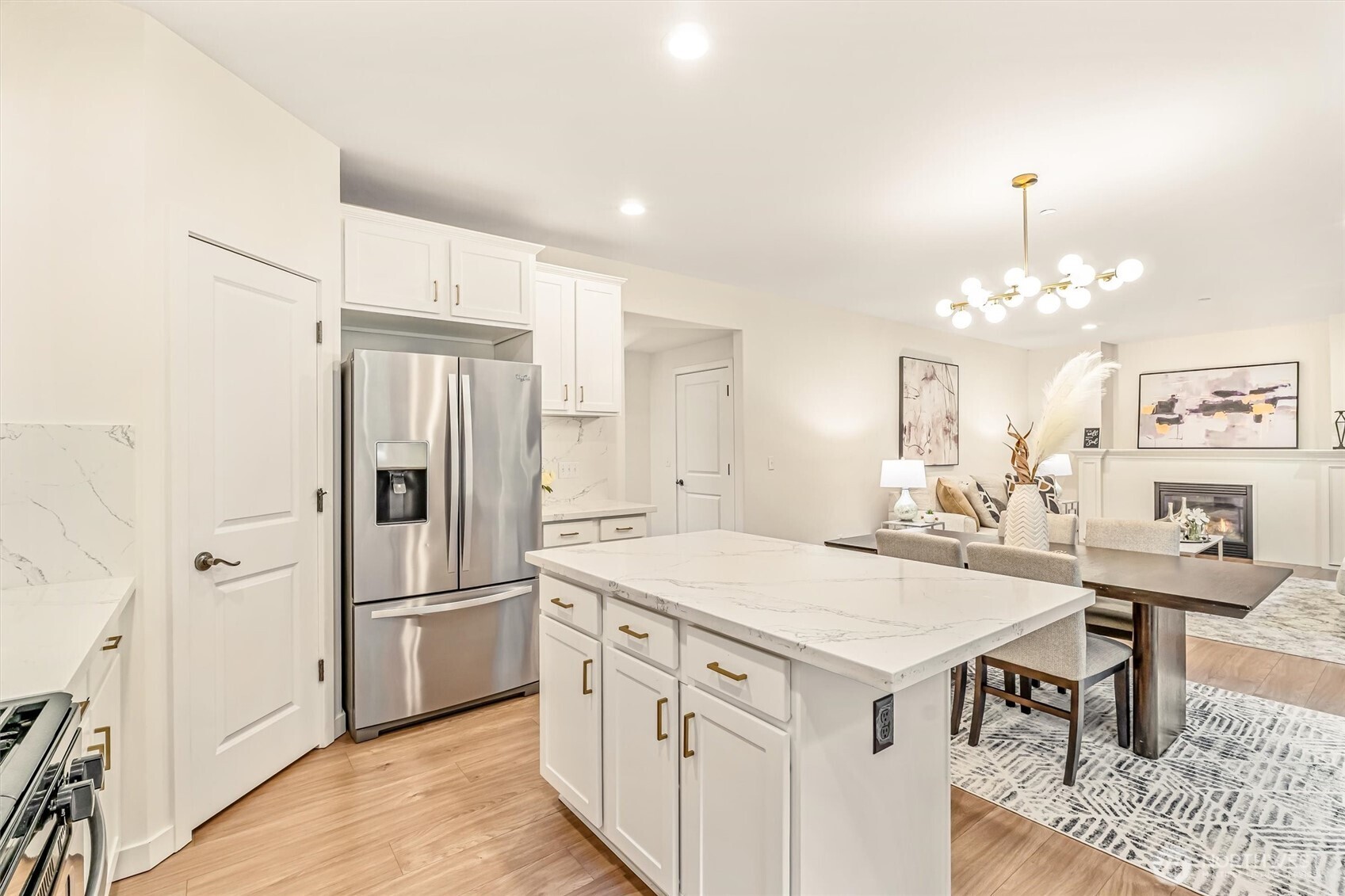 9213 Odin Way Bothell, WA 98011 - Photo 15 of 40 a kitchen that has a lot of white cabinets and stainless steel appliances