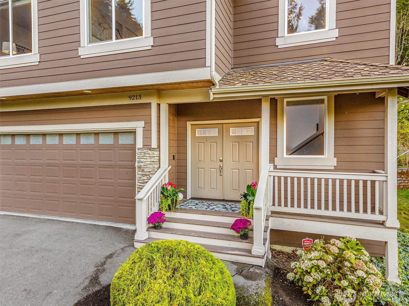 9213 Odin Way Bothell, WA 98011 - Photo 2 of 40 a front view of a house with a garage