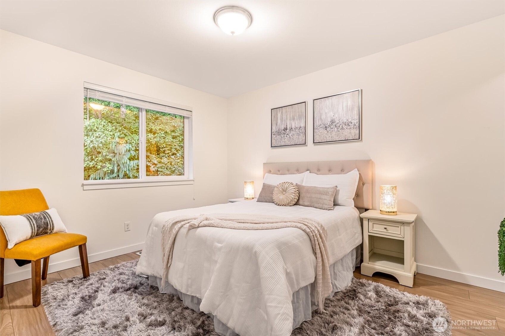 9213 Odin Way Bothell, WA 98011 - Photo 25 of 40 a bedroom with a bed a couch and a window
