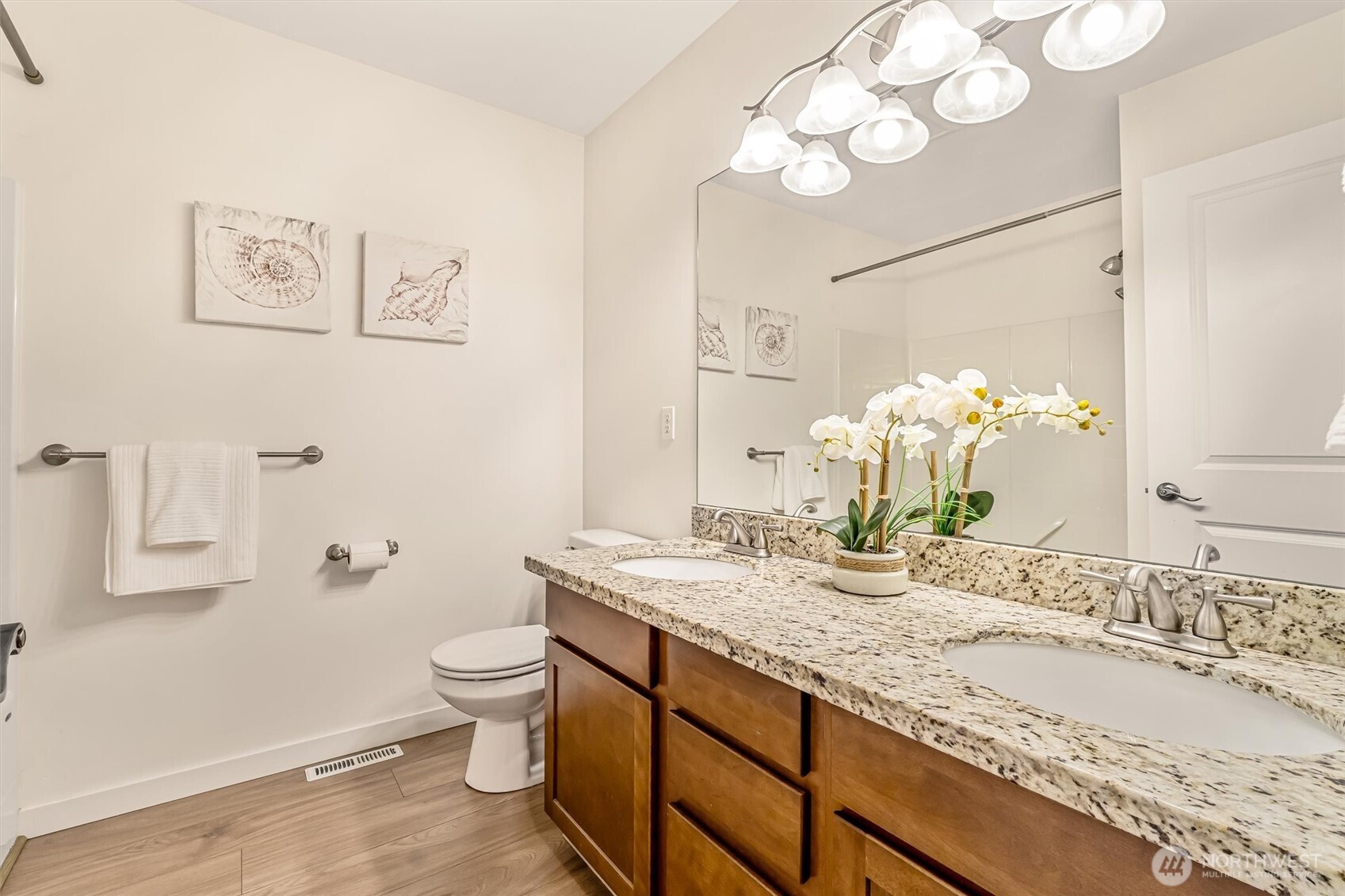 9213 Odin Way Bothell, WA 98011 - Photo 27 of 40 a bathroom with a granite countertop sink a toilet and a mirror