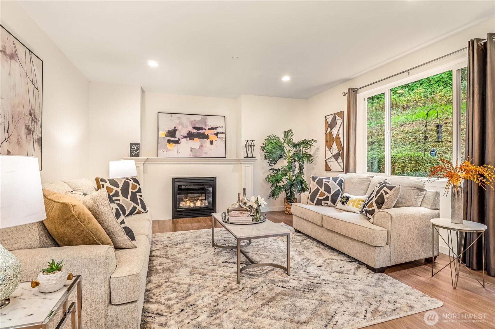 9213 Odin Way Bothell, WA 98011 - Photo 4 of 40 a living room with furniture a fireplace and a large window