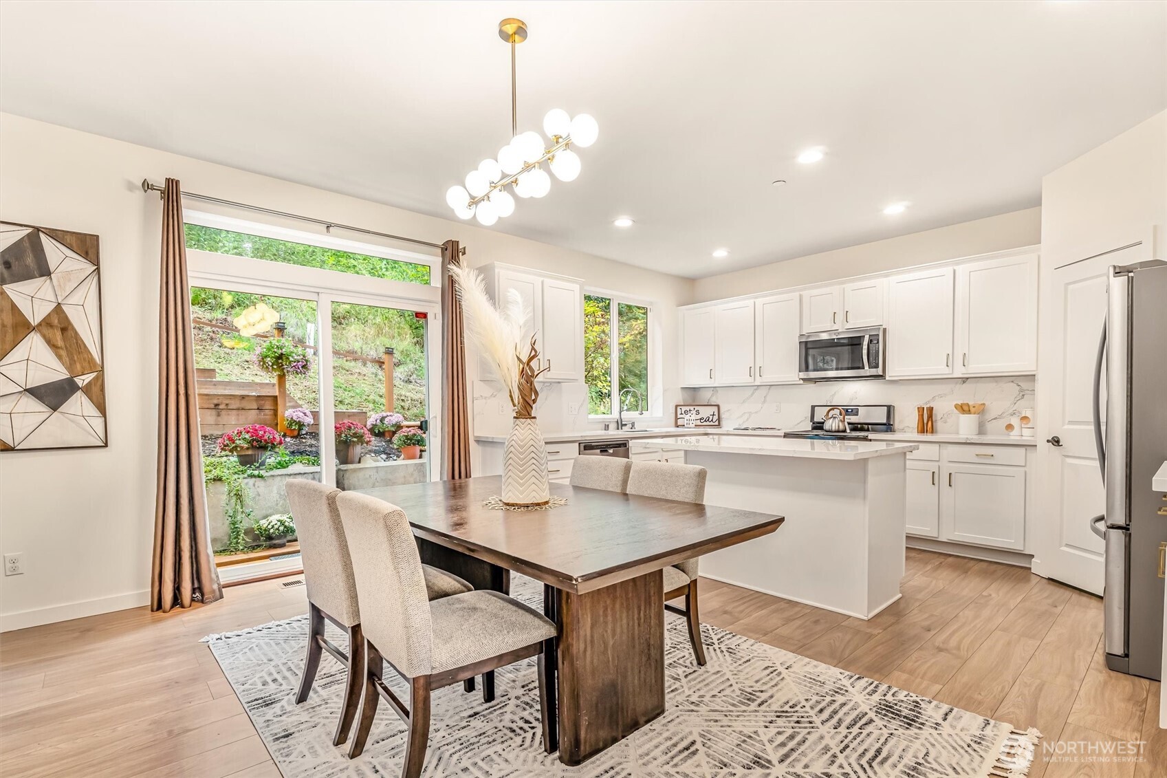 9213 Odin Way Bothell, WA 98011 - Photo 9 of 40 a view of a dining room with furniture window and wooden floor