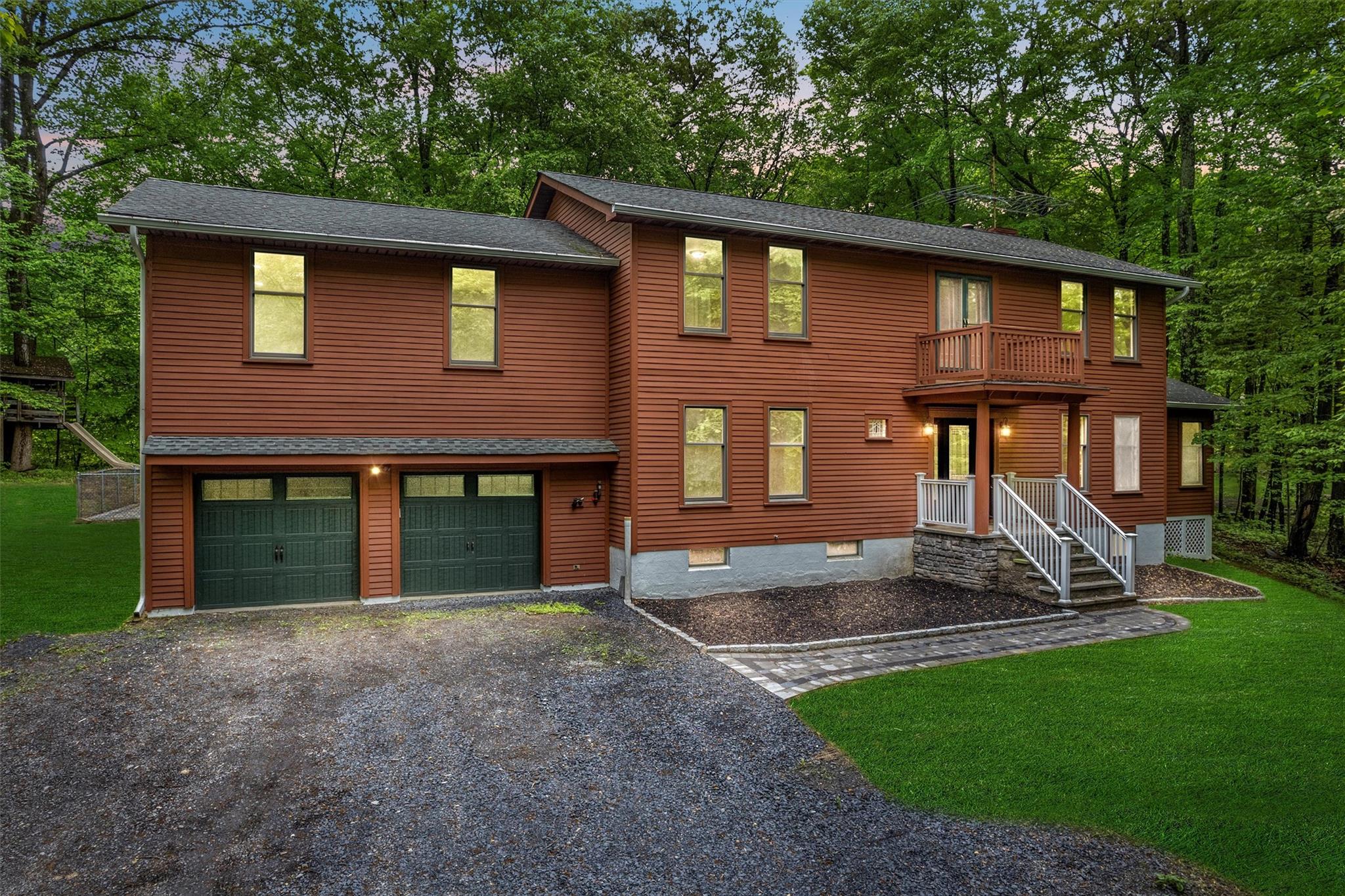 14 Still Hollow Road Newburgh, NY 12550 - Photo 1 of 1 View of front of house featuring an attached garage, a balcony, a front lawn, asphalt driveway, and a shingled roof