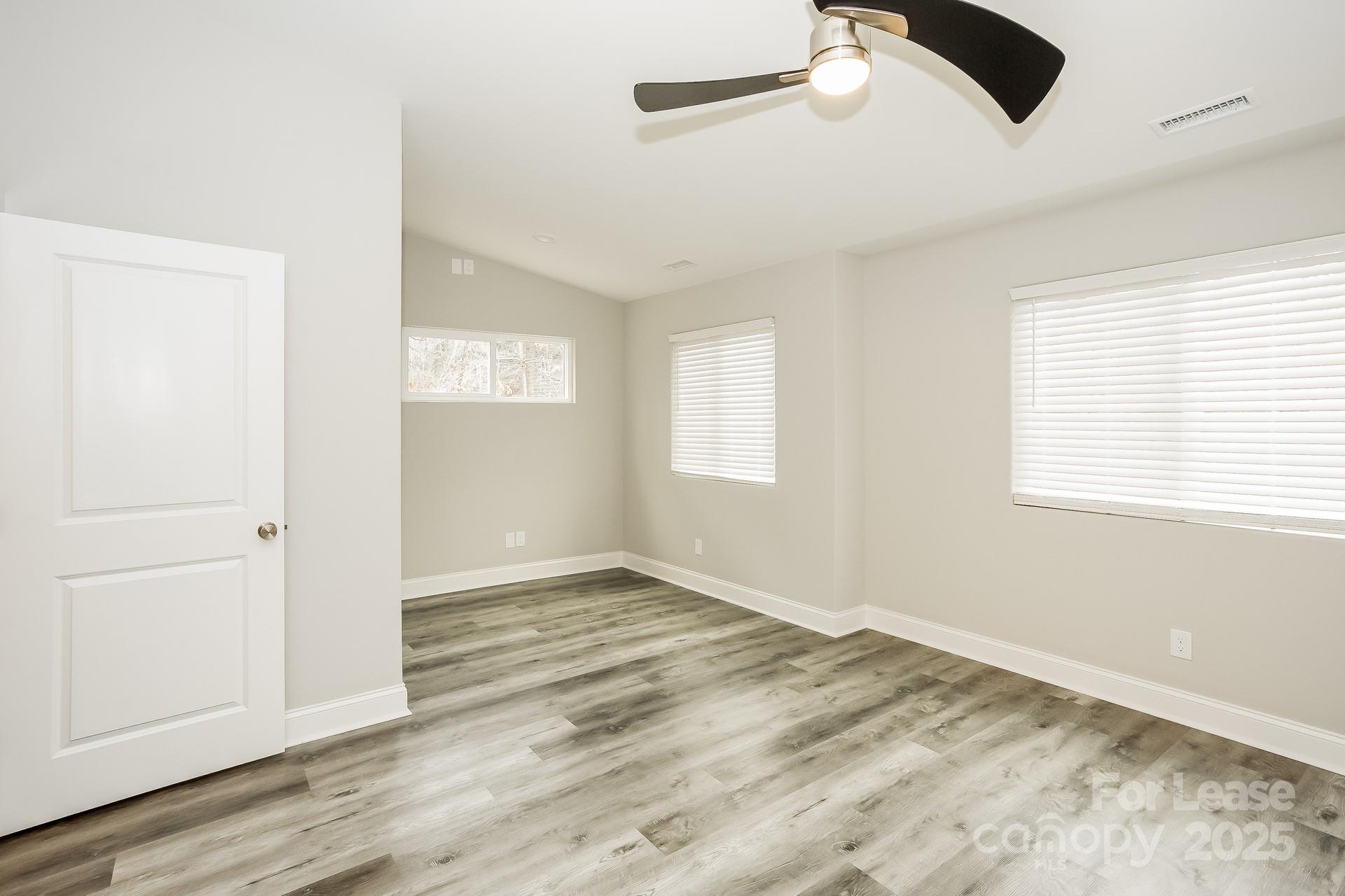 3987 Flat Rock Road Terrell, NC 28682 - Photo 14 of 17 a view of an empty room with wooden floor and a window