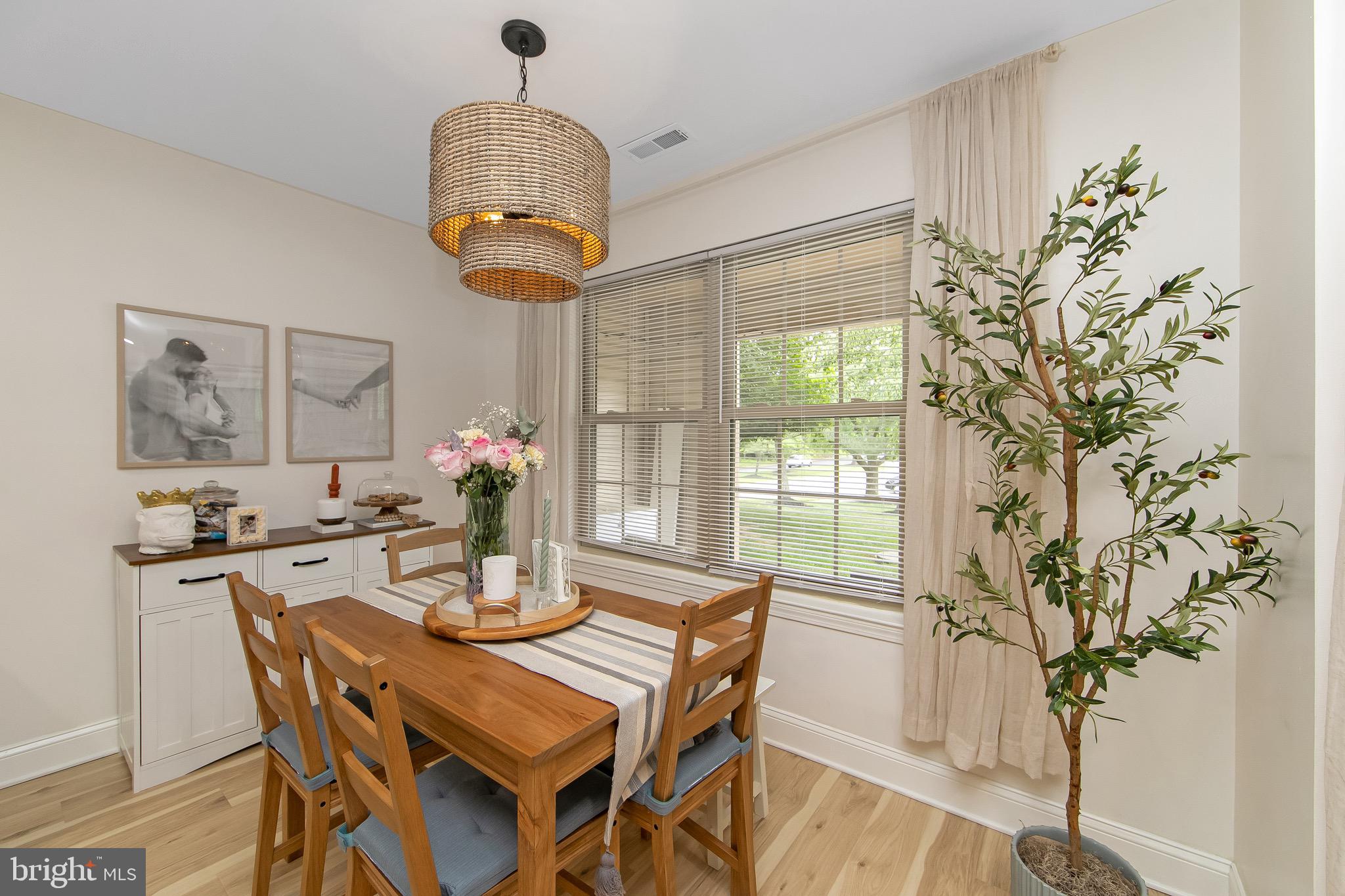 166 Tavistock Cherry Hill, NJ 08034 - Photo 12 of 38 a dining room with chandelier and wooden floor
