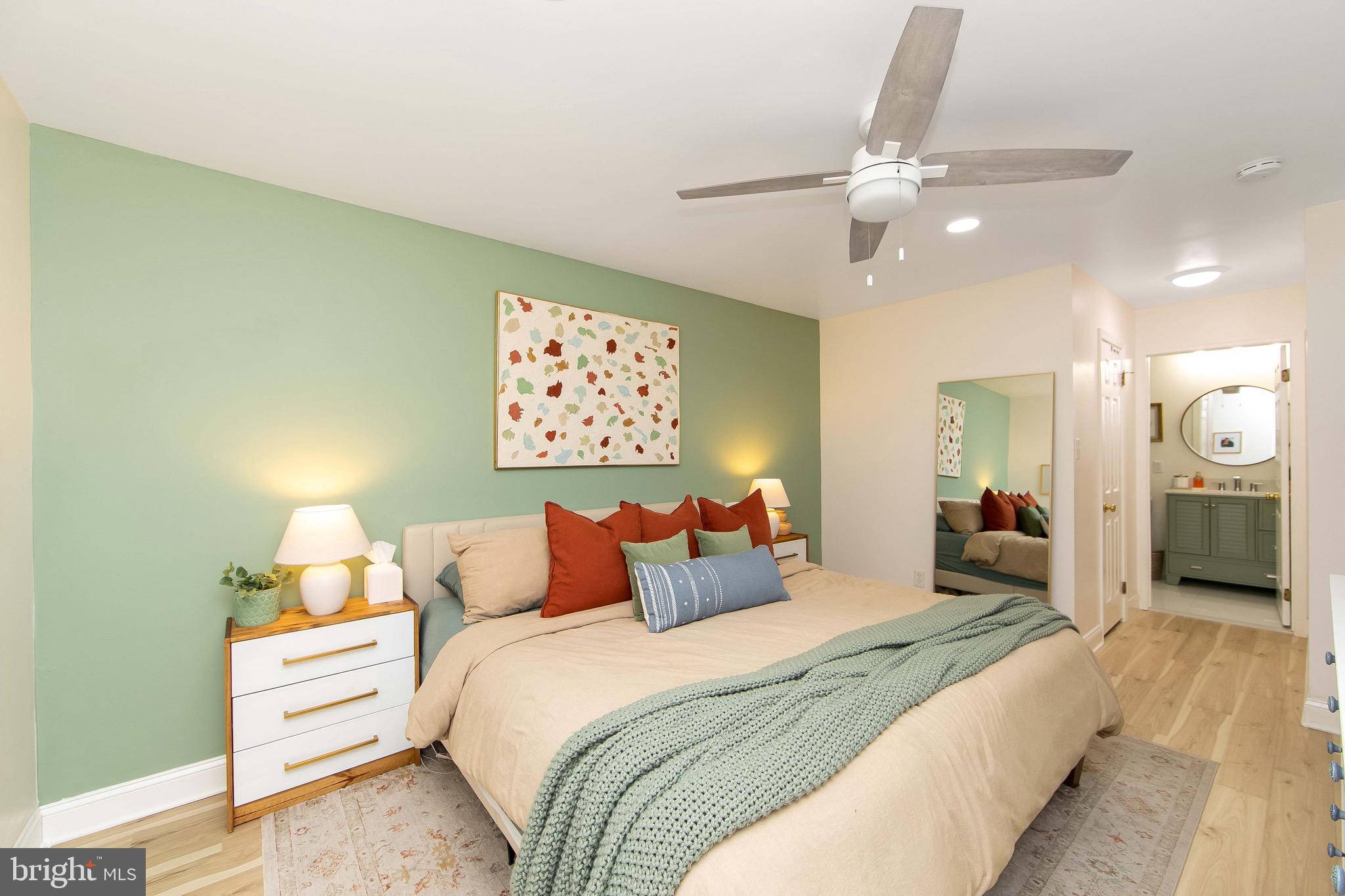 166 Tavistock Cherry Hill, NJ 08034 - Photo 15 of 38 a bedroom with a bed and a chandelier