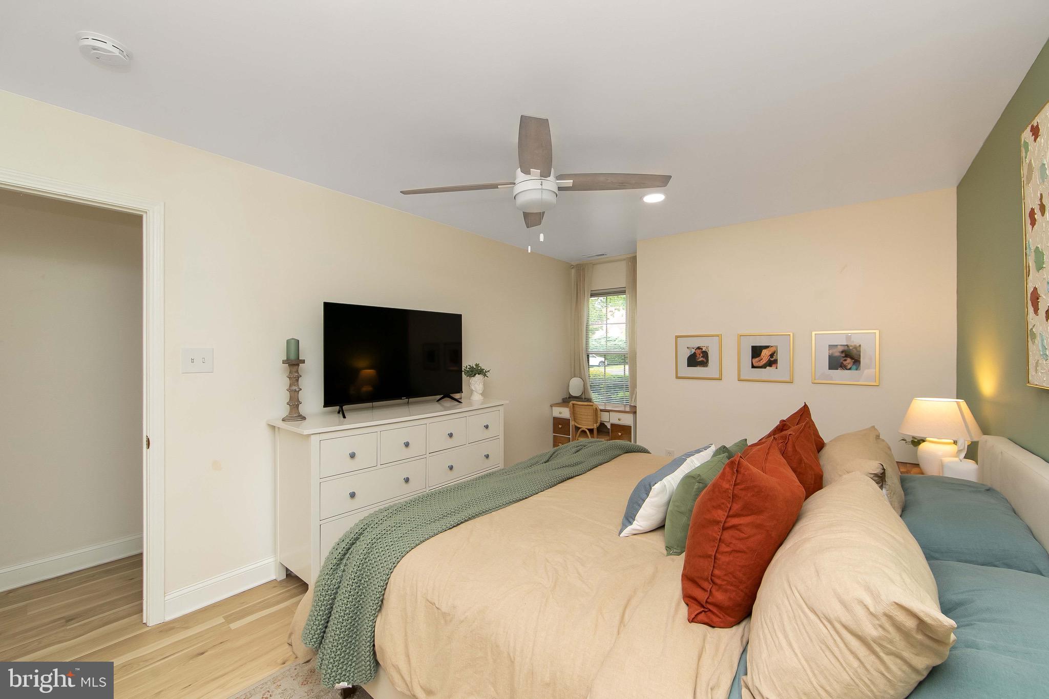 166 Tavistock Cherry Hill, NJ 08034 - Photo 17 of 38 a bedroom with a bed and a flat screen tv