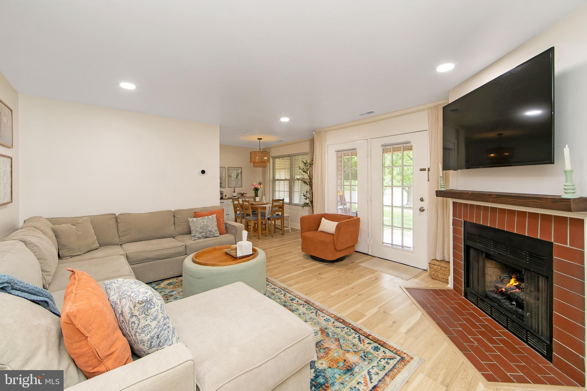 166 Tavistock Cherry Hill, NJ 08034 - Photo 4 of 38 a living room with furniture a flat screen tv and a fireplace