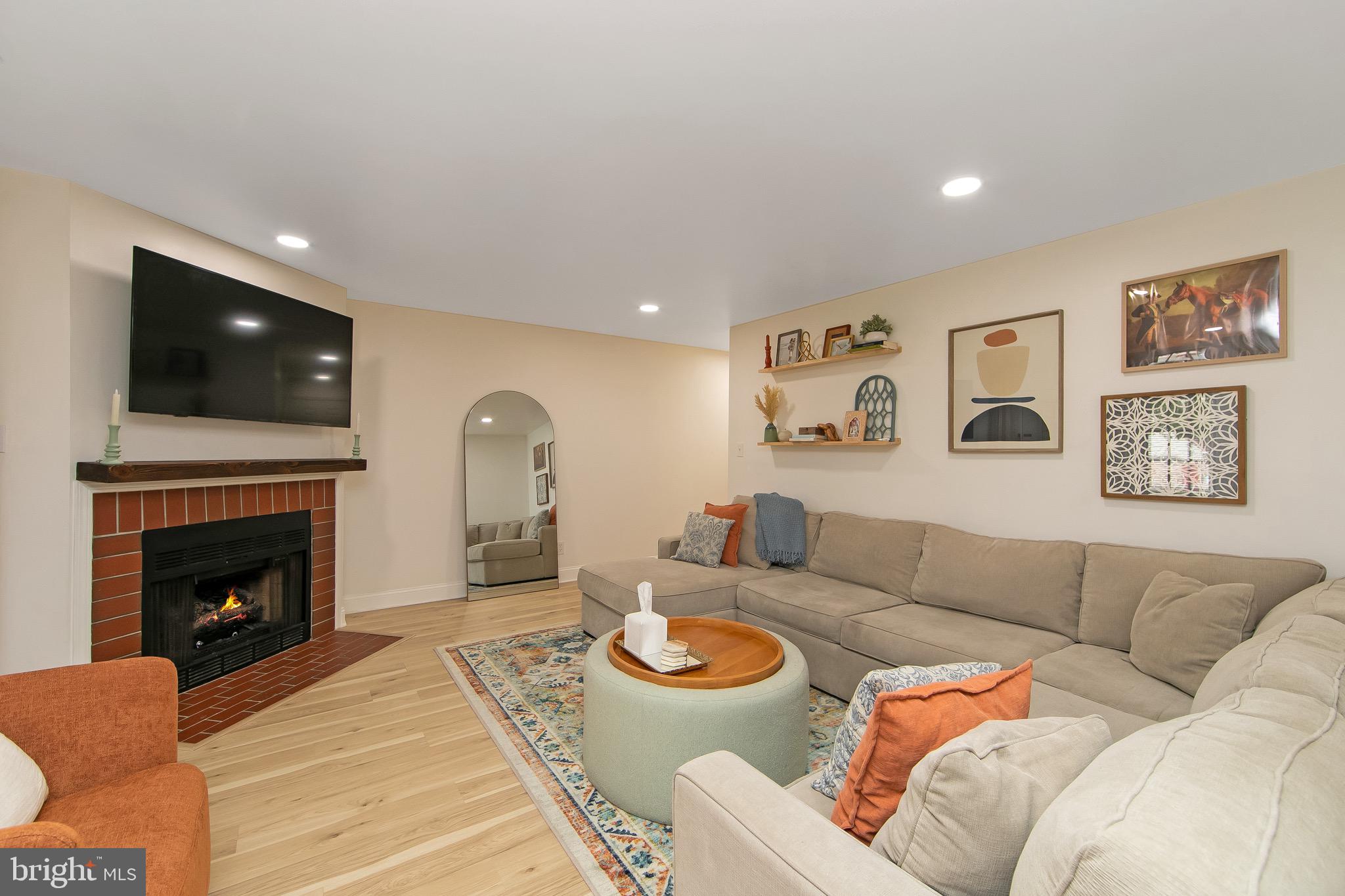 166 Tavistock Cherry Hill, NJ 08034 - Photo 5 of 38 a living room with furniture a fireplace and a flat screen tv