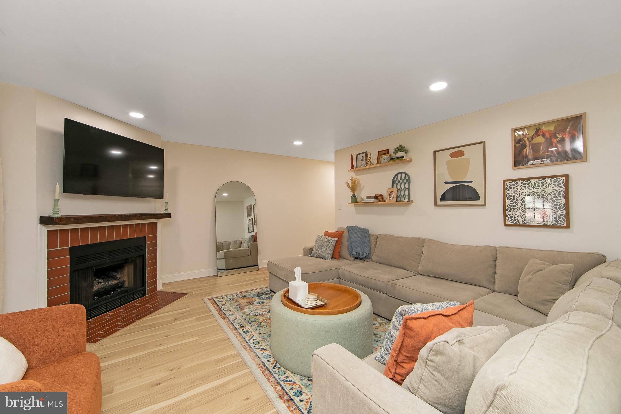 166 Tavistock Cherry Hill, NJ 08034 - Photo 8 of 38 a living room with furniture a fireplace and a flat screen tv