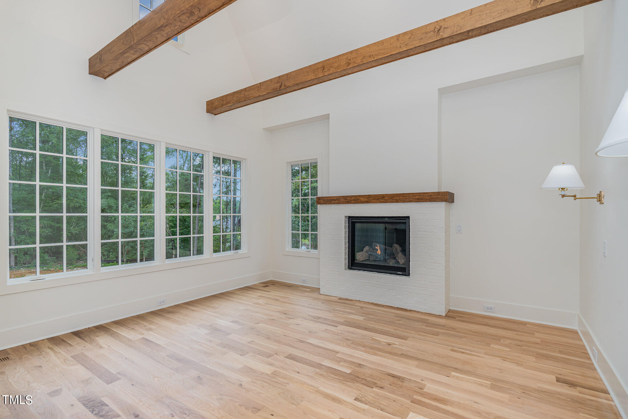 222 Kenwood Lane Pittsboro, NC 27312 - Photo 14 of 24 a view of an empty room with a window and a fireplace
