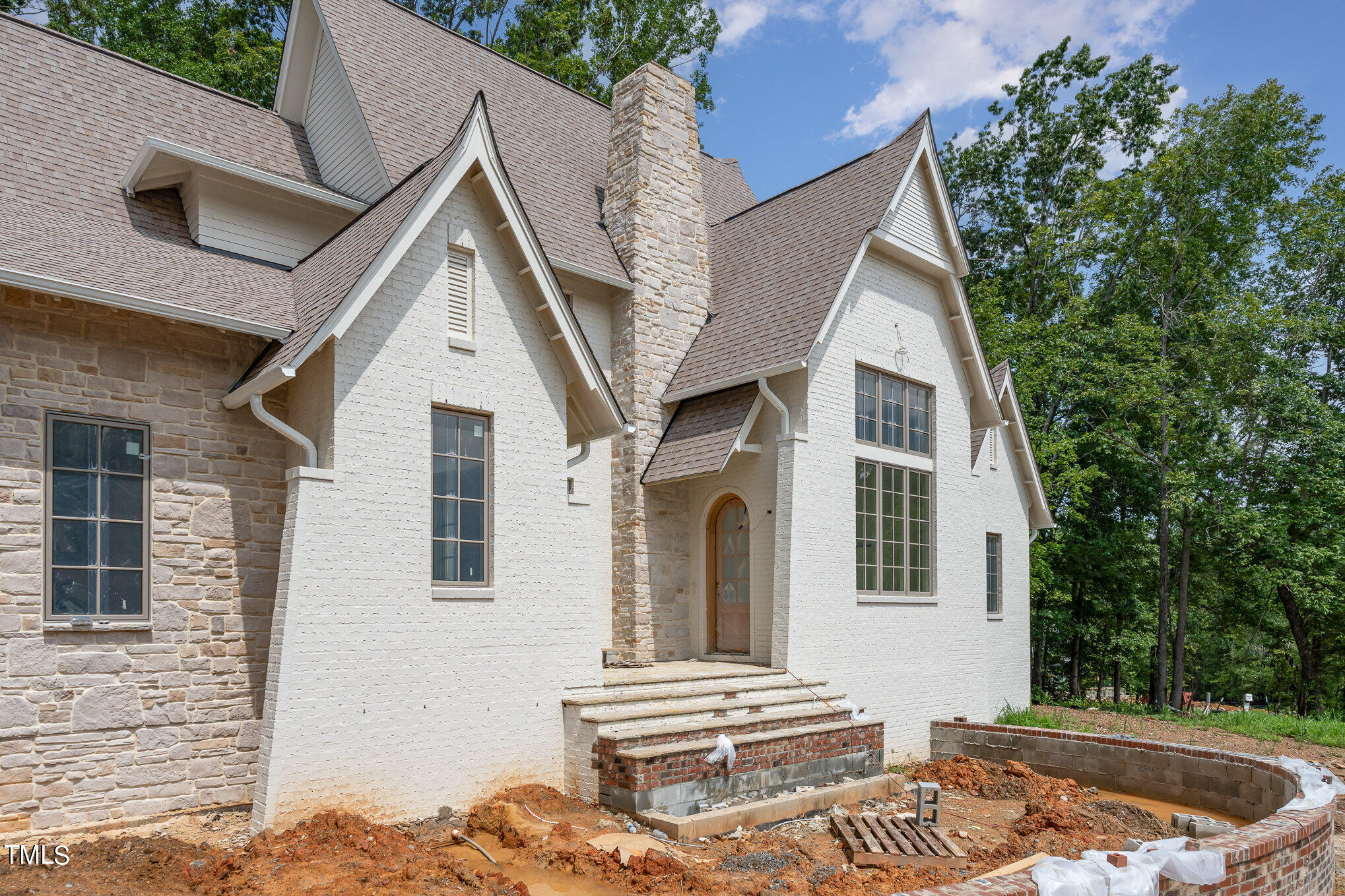 222 Kenwood Lane Pittsboro, NC 27312 - Photo 20 of 24 a view of a white house with a small yard and large tree