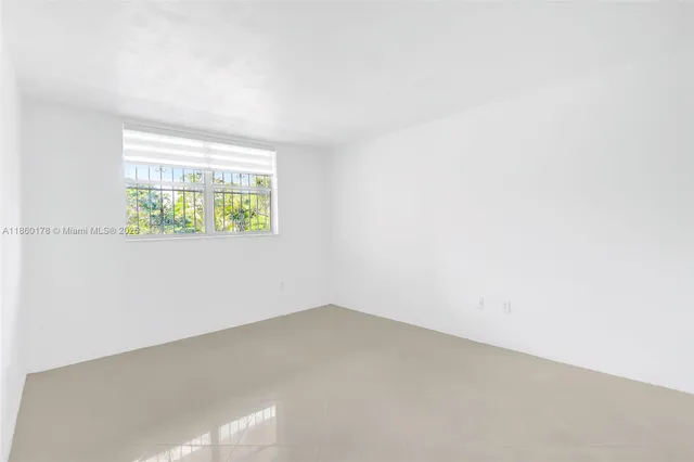 a bathroom with a bathtub shower sink vanity mirror and toilet