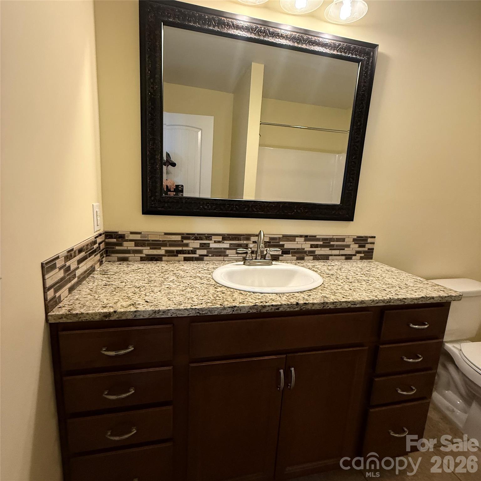 3523 Icard Rhodhiss Road Connelly Springs, NC 28612 - Photo 19 of 28 a bathroom with a granite countertop sink and a mirror