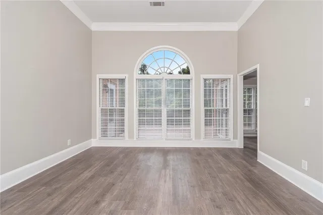 a view of wooden floor and a window in a room