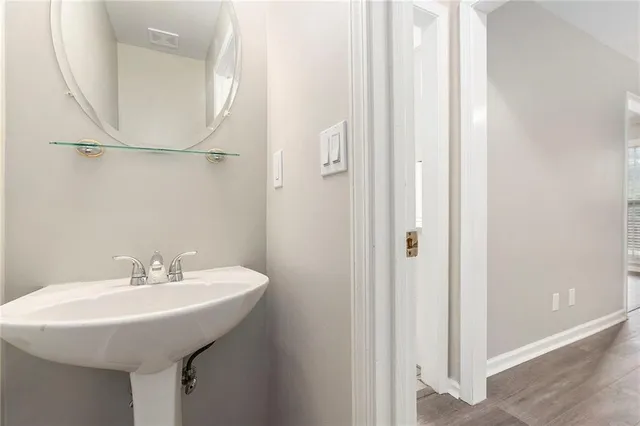 a bathroom with a sink a mirror and a shower