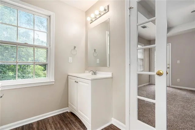 a bathroom with a sink a mirror and a shower