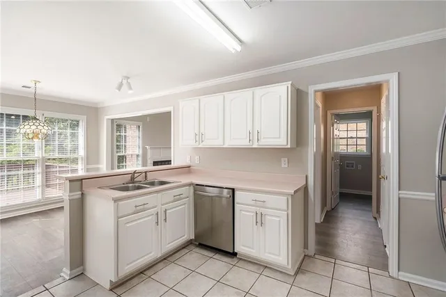 a kitchen with a stove sink and cabinets
