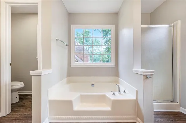 a white bath tub sitting next to a white toilet