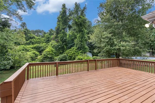 a balcony with wooden floor and fence