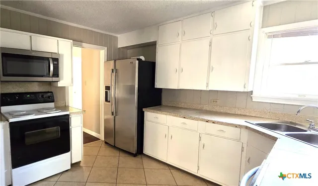 a kitchen with a stove microwave and refrigerator