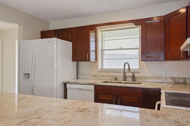 a large kitchen with kitchen island a sink stainless steel appliances and cabinets