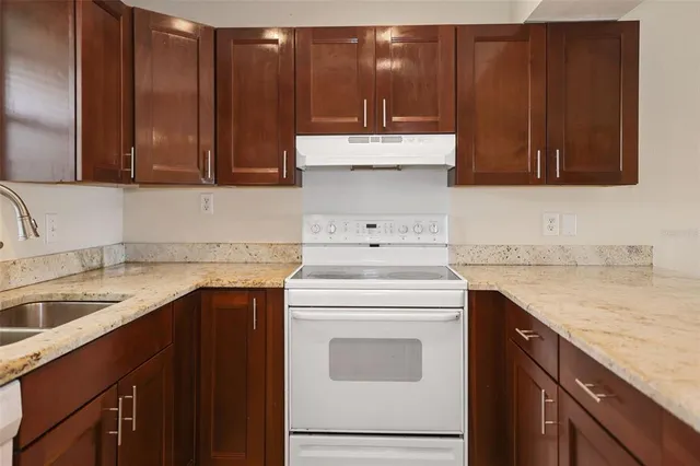 an empty room with closet and windows