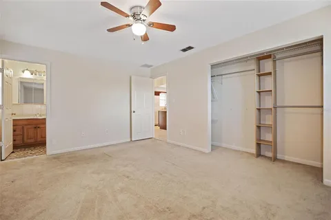 a view of an empty room with a ceiling fan