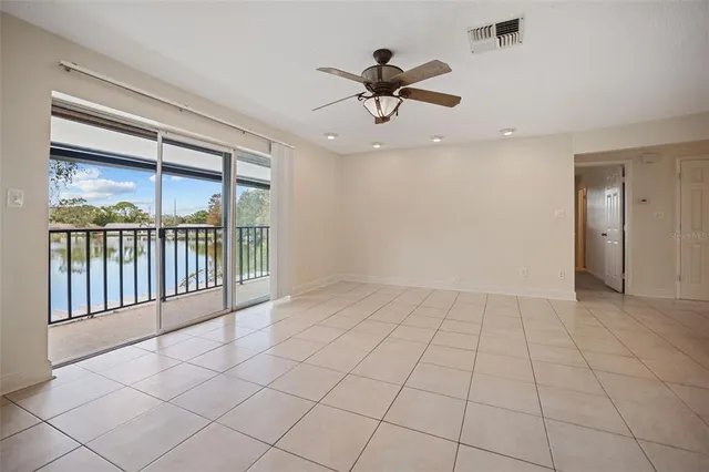 a view of a livingroom with a ceiling fan and window