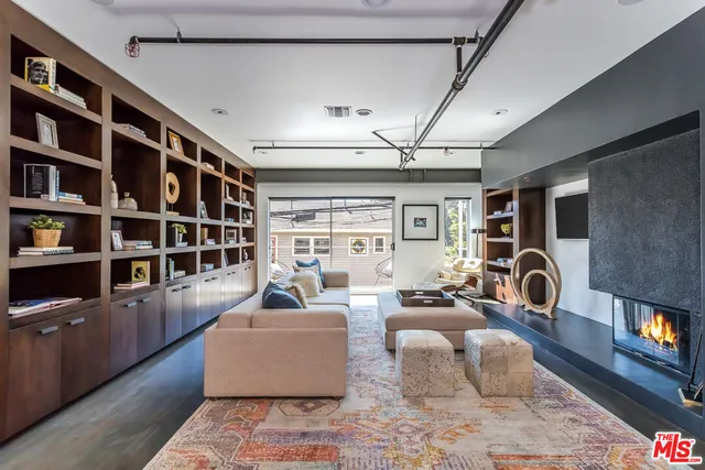 a living room with furniture and a bookshelf