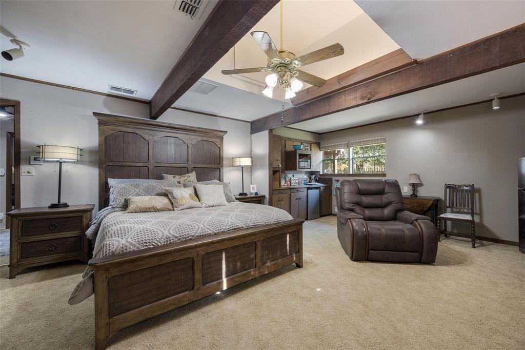 236 County Road 1422 Quitman, TX 75783 - Photo 12 of 34 Bedroom with rail lighting, beam ceiling, visible vents, and light carpet