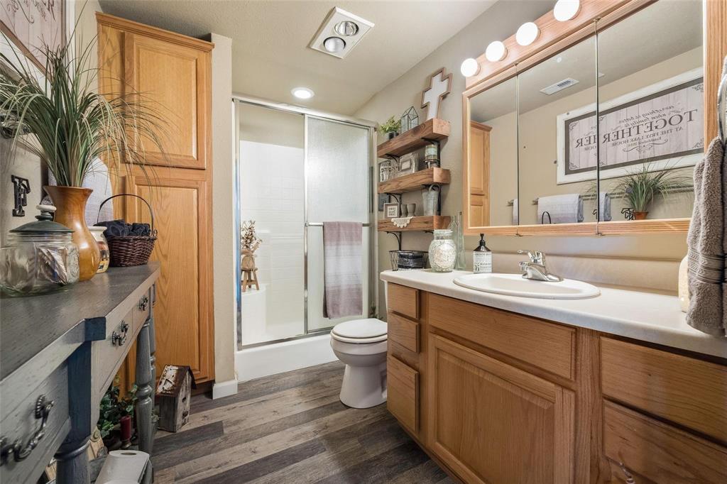 236 County Road 1422 Quitman, TX 75783 - Photo 22 of 34 Full bathroom featuring visible vents, toilet, vanity, a shower stall, and wood finished floors