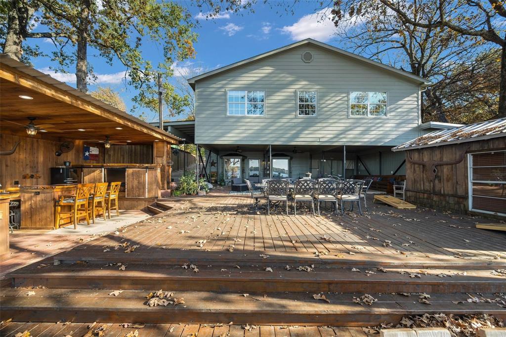 236 County Road 1422 Quitman, TX 75783 - Photo 28 of 34 Rear view of property featuring outdoor dry bar, a deck, and a ceiling fan