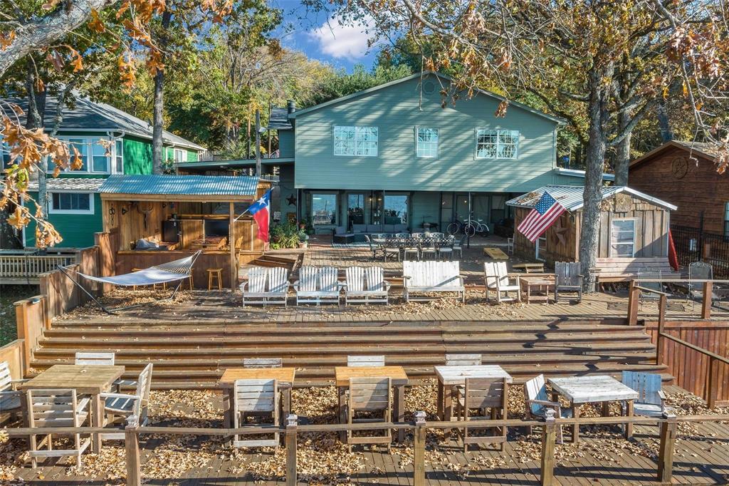 236 County Road 1422 Quitman, TX 75783 - Photo 32 of 34 Back of property featuring a deck, outdoor dining area, and fence