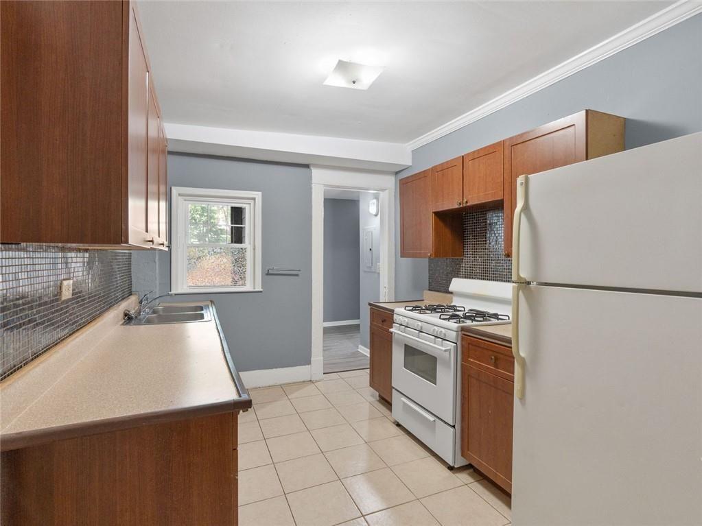 164 4th Street Northeast, Unit 9 Atlanta, GA 30308 - Photo 11 of 18 a kitchen with a stove a refrigerator and a sink