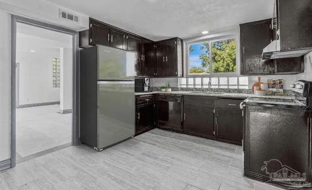 a bathroom with a granite countertop toilet a sink and a mirror