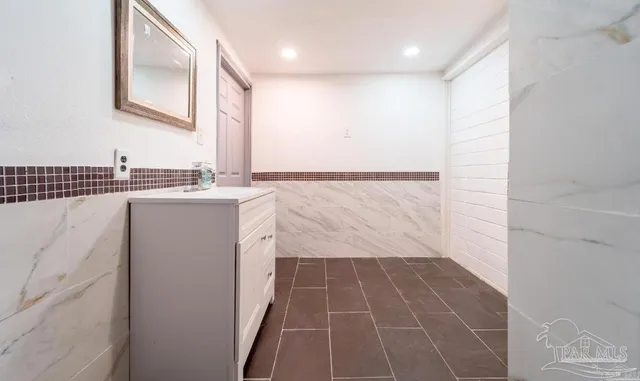 a bathroom with a bathtub and window