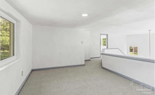 a view of an empty room and a window