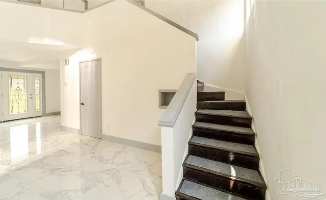 a view of an empty room with stairs