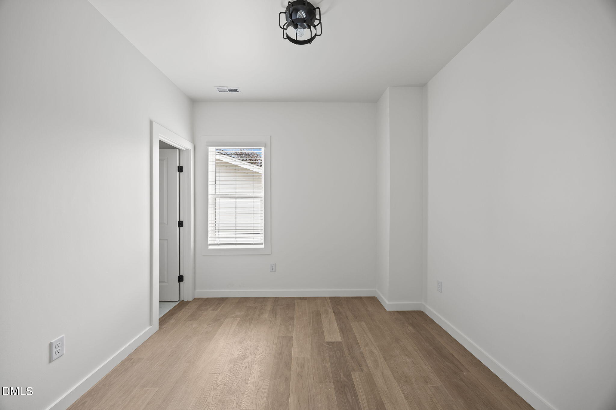 2811 Wilcox Place, Unit 101 Raleigh, NC 27607 - Photo 17 of 29 a view of a livingroom with wooden floor and window