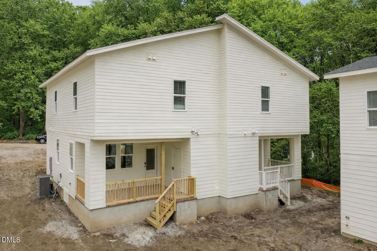 2811 Wilcox Place, Unit 101 Raleigh, NC 27607 - Photo 18 of 29 a view of a white house with a small yard and large tree