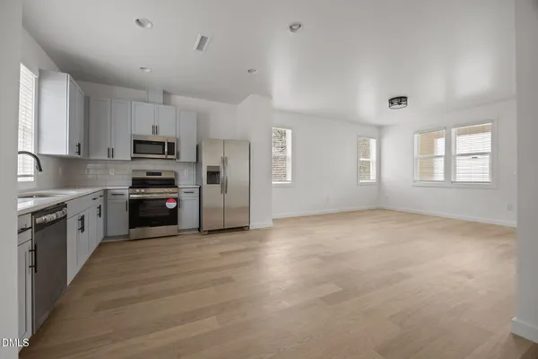a view of a livingroom with wooden floor and window
