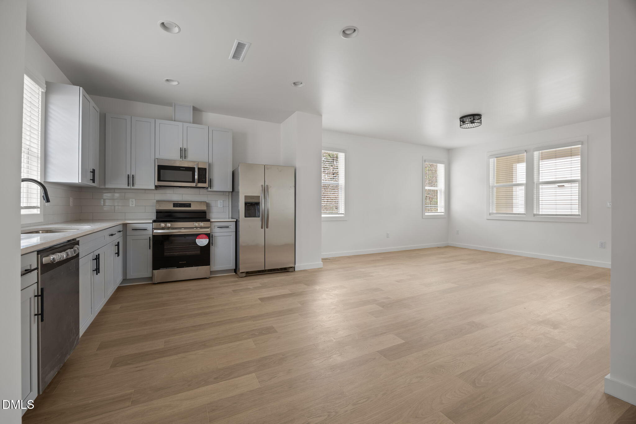 2811 Wilcox Place, Unit 101 Raleigh, NC 27607 - Photo 19 of 29 a kitchen with stainless steel appliances a refrigerator sink and microwave